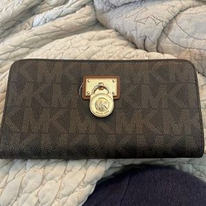 Michael Kors zip up wallet, brown with like brown MK signature.